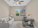 Bright office with a comfortable sofa, desk and chair, plus a ceiling fan at 12029 Perennial Pl, Lakewood Ranch, FL 34211