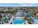 Aerial view of a community pool, surrounding palm trees and nearby lake at 12029 Perennial Pl, Lakewood Ranch, FL 34211