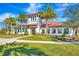 Exterior of the community clubhouse featuring lush landscaping and a welcoming entrance, perfect for community gatherings at 3218 Big Sky Way, Bradenton, FL 34211