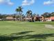 Beautiful view of a meticulously maintained golf course with palm trees and picturesque residential houses at 4202 Caddie E Dr # 202, Bradenton, FL 34203