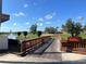 Scenic view of golf course featuring a charming wooden bridge over water at 4202 Caddie E Dr # 202, Bradenton, FL 34203