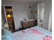 Cozy bedroom featuring flamingo bedding, vanity area, and adjacent bathroom at 4509 10Th Street E Ct, Ellenton, FL 34222