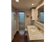 Bathroom features tile flooring, a white vanity with marble top and large mirror at 4900 38Th S Way # 201, St Petersburg, FL 33711