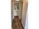 Hallway view of bathroom with tile flooring, white vanity with marble top, and walk-in shower at 4900 38Th S Way # 201, St Petersburg, FL 33711