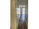 Hallway with hardwood floors leading to a sliding glass door and outdoor patio at 4900 38Th S Way # 201, St Petersburg, FL 33711