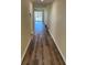 Hallway with hardwood floors leading into a naturally lit living space with sliding glass doors at 4900 38Th S Way # 201, St Petersburg, FL 33711