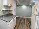 Kitchen features white cabinets, granite counters and wood-look flooring extending into the dining area at 4900 38Th S Way # 201, St Petersburg, FL 33711