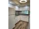 Well-lit kitchen featuring white cabinets, appliances, and modern countertops at 4900 38Th S Way # 201, St Petersburg, FL 33711