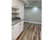 Kitchen features modern white cabinets and wood-look flooring extending into the dining area at 4900 38Th S Way # 201, St Petersburg, FL 33711