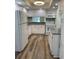 Bright kitchen features white cabinets, wood-look flooring and a full appliance package at 4900 38Th S Way # 201, St Petersburg, FL 33711