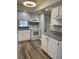 Bright kitchen featuring white appliances, countertops, and modern cabinetry at 4900 38Th S Way # 201, St Petersburg, FL 33711