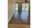 Bright living room with modern hardwood floors, fan, and sliding doors leading to a balcony at 4900 38Th S Way # 201, St Petersburg, FL 33711