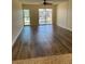 Inviting living room featuring hardwood floors, a ceiling fan, and access to a private balcony at 4900 38Th S Way # 201, St Petersburg, FL 33711