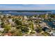 The aerial view displays a coastal neighborhood with lush trees, showcasing the property's prime location near the water at 5500 Bayou Grande Ne Blvd, St Petersburg, FL 33703