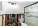 Bathroom renovation shows exposed studs, toilet, and glass-door shower, offering a glimpse of the remodeling potential at 5500 Bayou Grande Ne Blvd, St Petersburg, FL 33703