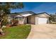 Charming single-story home featuring a brick facade, attached garage, and well-manicured landscaping on a sunny day at 5500 Bayou Grande Ne Blvd, St Petersburg, FL 33703