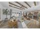 Spacious living room featuring beamed ceilings, an open layout, and sliding glass doors to the outdoor space at 6039 Salt Grass St, Bradenton, FL 34210