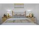 Relaxing main bedroom featuring a bed with a patterned blanket and decorative pillows and bedside tables at 6039 Salt Grass St, Bradenton, FL 34210