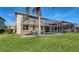 This backyard has a screened-in pool, grassy area and a view of the water and trees beyond at 6920 74Th Street E Cir, Bradenton, FL 34203