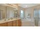 Elegant bathroom features double sinks, a garden tub, and a glass-enclosed shower at 6920 74Th Street E Cir, Bradenton, FL 34203