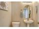 Convenient half-bath with pedestal sink, toilet, and coastal-themed decor at 6920 74Th Street E Cir, Bradenton, FL 34203