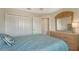 Cozy bedroom featuring a wooden dresser and closet for storing personal items at 6920 74Th Street E Cir, Bradenton, FL 34203