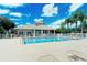 Beautiful clubhouse pool surrounded by lush landscaping and lounge chairs, ideal for relaxation at 6920 74Th Street E Cir, Bradenton, FL 34203