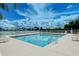 Inviting community pool with clear blue water, lounge chairs, and a view of the beautiful skyline at 6920 74Th Street E Cir, Bradenton, FL 34203