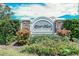 Welcome to River Place community sign with lush landscaping and colorful flowers at 6920 74Th Street E Cir, Bradenton, FL 34203
