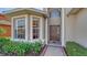 Inviting front entrance boasts a decorative door, bay window, and lush landscaping for curb appeal at 6920 74Th Street E Cir, Bradenton, FL 34203