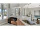 Stylish kitchenette featuring a modern countertop, sleek sink, microwave, and warm wood cabinetry at 6920 74Th Street E Cir, Bradenton, FL 34203