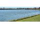 Scenic lake view with lush green grass and beautiful neighborhood houses in the background at 6920 74Th Street E Cir, Bradenton, FL 34203