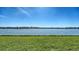 Serene lake view showcasing the calm water and the beautifully maintained green lawn in the foreground at 6920 74Th Street E Cir, Bradenton, FL 34203