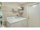 Functional laundry room equipped with washer, dryer, and overhead storage shelves at 6920 74Th Street E Cir, Bradenton, FL 34203