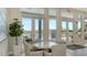 Bright lounge area featuring a round table set with chairs near floor-to-ceiling windows with pool views at 6920 74Th Street E Cir, Bradenton, FL 34203