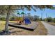 Community playground featuring colorful slides and swings in a safe, shaded area for children to enjoy at 6920 74Th Street E Cir, Bradenton, FL 34203