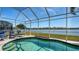 Enjoy swimming in this kidney-shaped screened-in pool with a view of the water and trees beyond at 6920 74Th Street E Cir, Bradenton, FL 34203