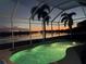 Enclosed pool and spa area offers stunning twilight views over the lake creating a picturesque setting at 6920 74Th Street E Cir, Bradenton, FL 34203