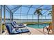 Enjoy the view of the water from this screened-in pool with cushioned lounge chairs for relaxing at 6920 74Th Street E Cir, Bradenton, FL 34203