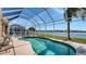 Enjoy swimming in this kidney-shaped screened-in pool with a view of the water and homes beyond at 6920 74Th Street E Cir, Bradenton, FL 34203
