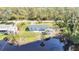 Beautiful aerial shot of a house with a large pond in the back, surrounded by trees at 712 N Elm St, Englewood, FL 34223