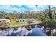 Aerial view of a charming house with a lake in the backyard at 712 N Elm St, Englewood, FL 34223
