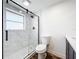 Bathroom featuring a glass shower with marble surround and modern fixtures at 712 N Elm St, Englewood, FL 34223