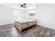 Bedroom featuring wood-look floors, neutral walls, and natural light at 712 N Elm St, Englewood, FL 34223