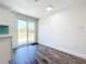 Bright dining area near a kitchen, featuring a sliding glass door and wood-look floors at 712 N Elm St, Englewood, FL 34223