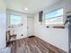 Laundry room features wood-look floor, a utility sink, and a back door at 712 N Elm St, Englewood, FL 34223