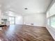 Spacious living room with wood-look floors and a large window providing lots of natural light at 712 N Elm St, Englewood, FL 34223