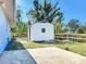 The outdoor outbuilding sits on a concrete foundation, fenced for added security at 712 N Elm St, Englewood, FL 34223