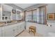 Updated bathroom features double vanity, tile floors, and a window for natural light at 7820 Seville Cir, Bradenton, FL 34209