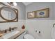 Charming half bathroom featuring neutral paint, framed fish art, and updated fixtures at 7820 Seville Cir, Bradenton, FL 34209